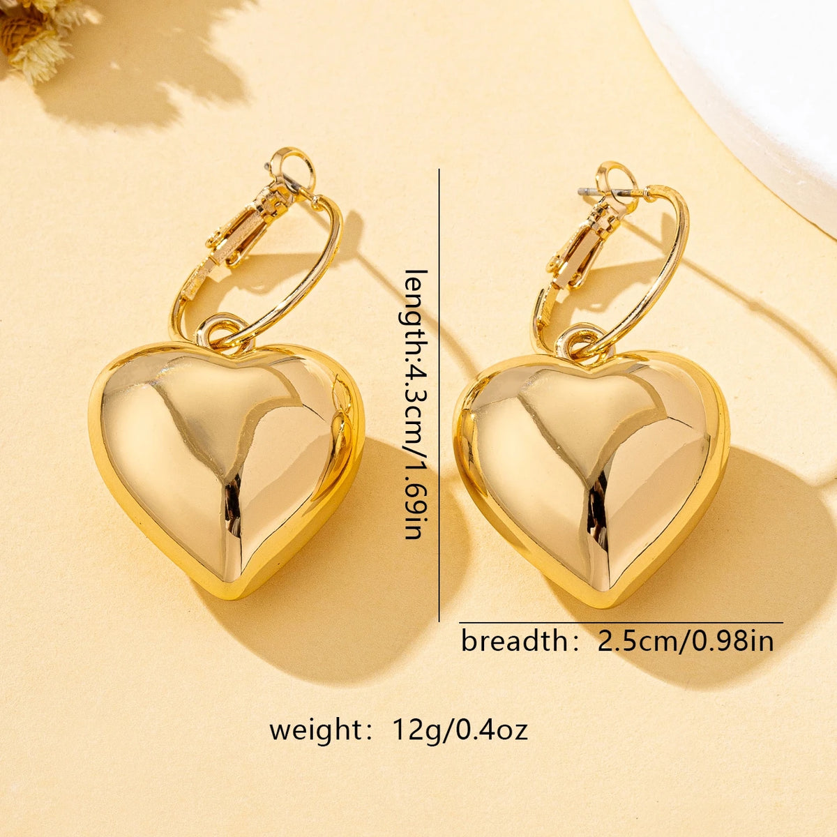Un par de pendientes de moda para mujer en forma de corazón liso, oro - plata