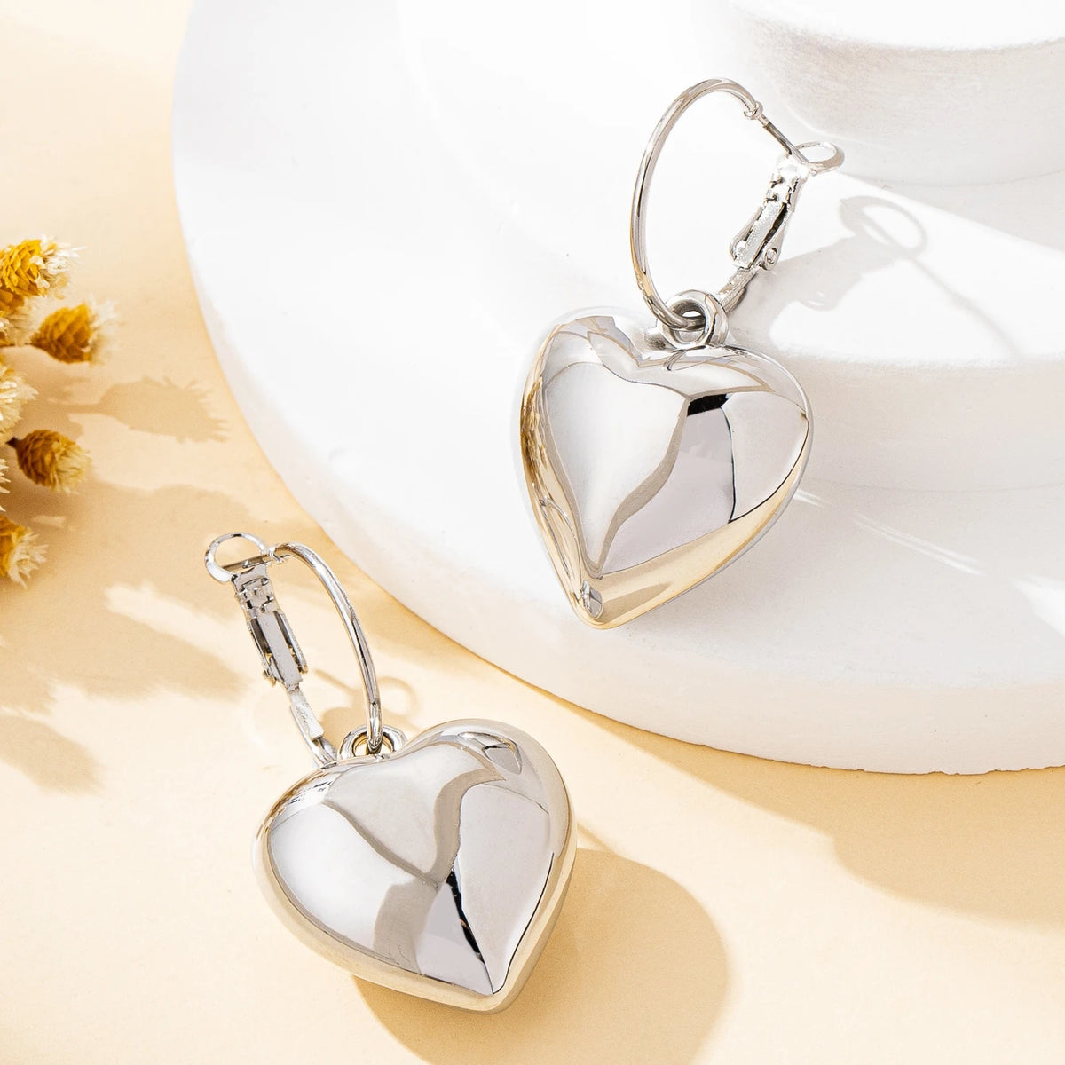 Un par de pendientes de moda para mujer en forma de corazón liso, oro - plata